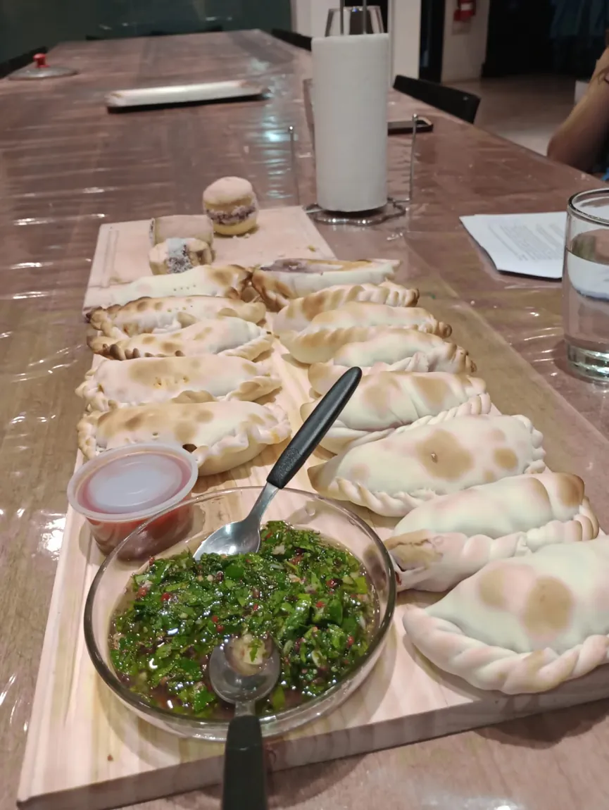 Empanadas and alfajores made during the cooking class, with chimichurri