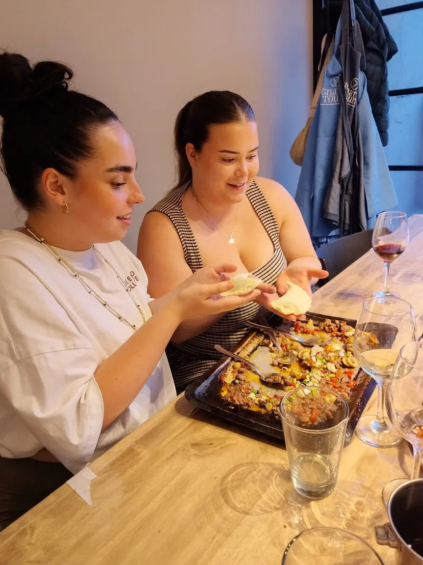 Two guests cooking at the kitchen counter